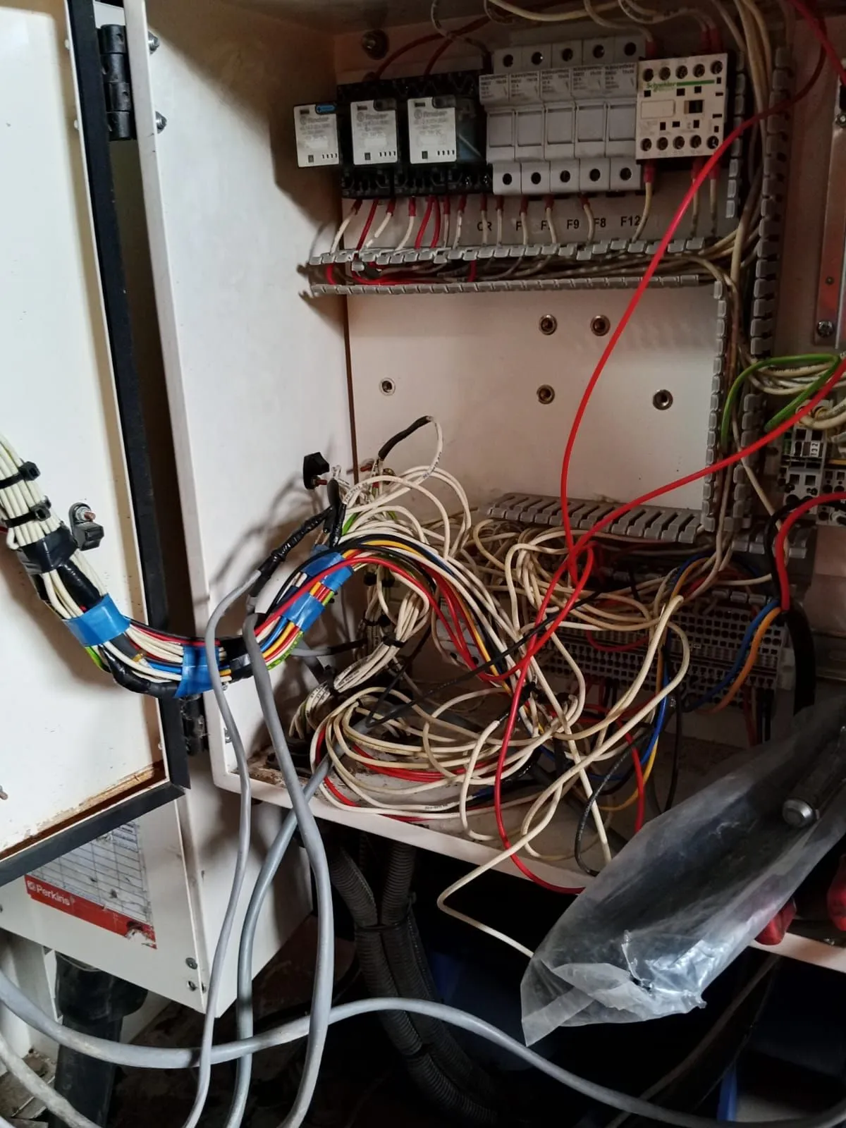 Generator control cabinet with relays, fuses and control wiring being re-terminated