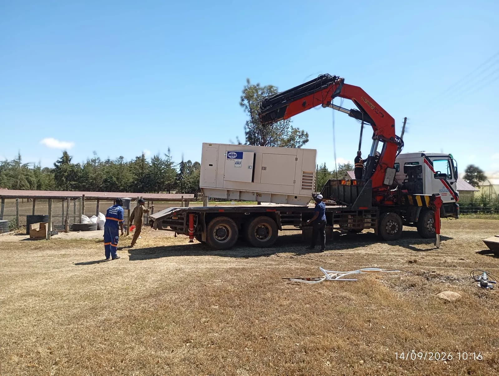 Team securing a canopy generator on a crane truck