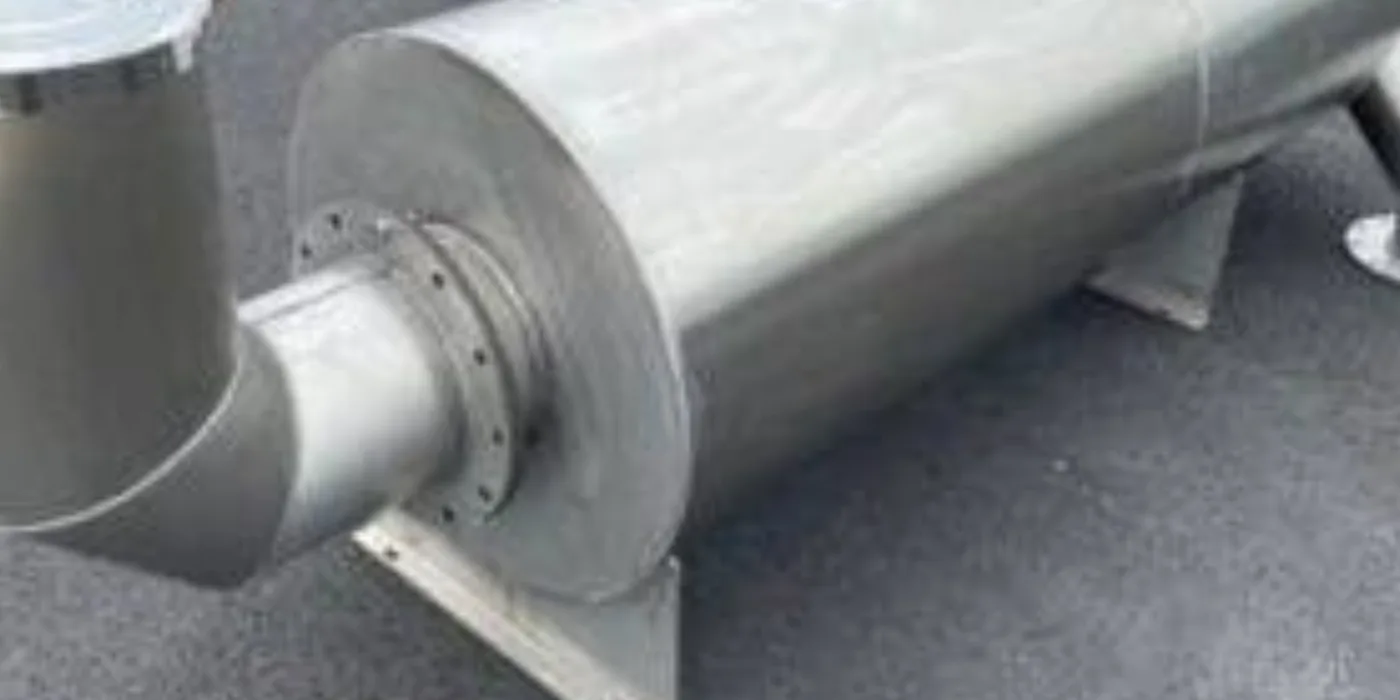 Large fabricated industrial exhaust silencer with flanged inlet and support feet