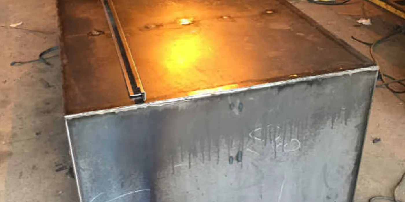Fabricated rectangular steel diesel fuel tank under construction with welded seams in the EmersonEIMS workshop