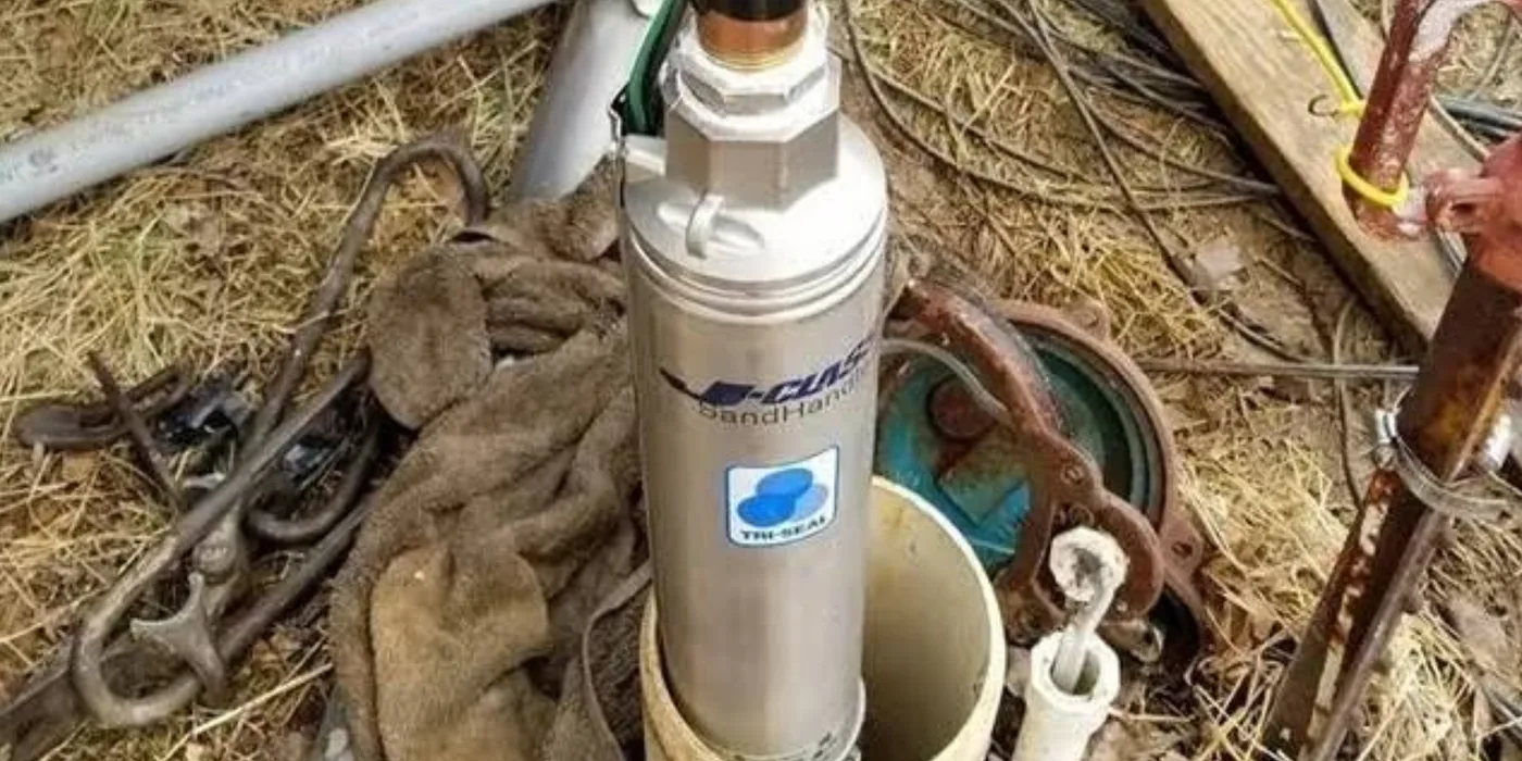 Stainless-steel submersible borehole pump at the wellhead during removal and inspection by EmersonEIMS