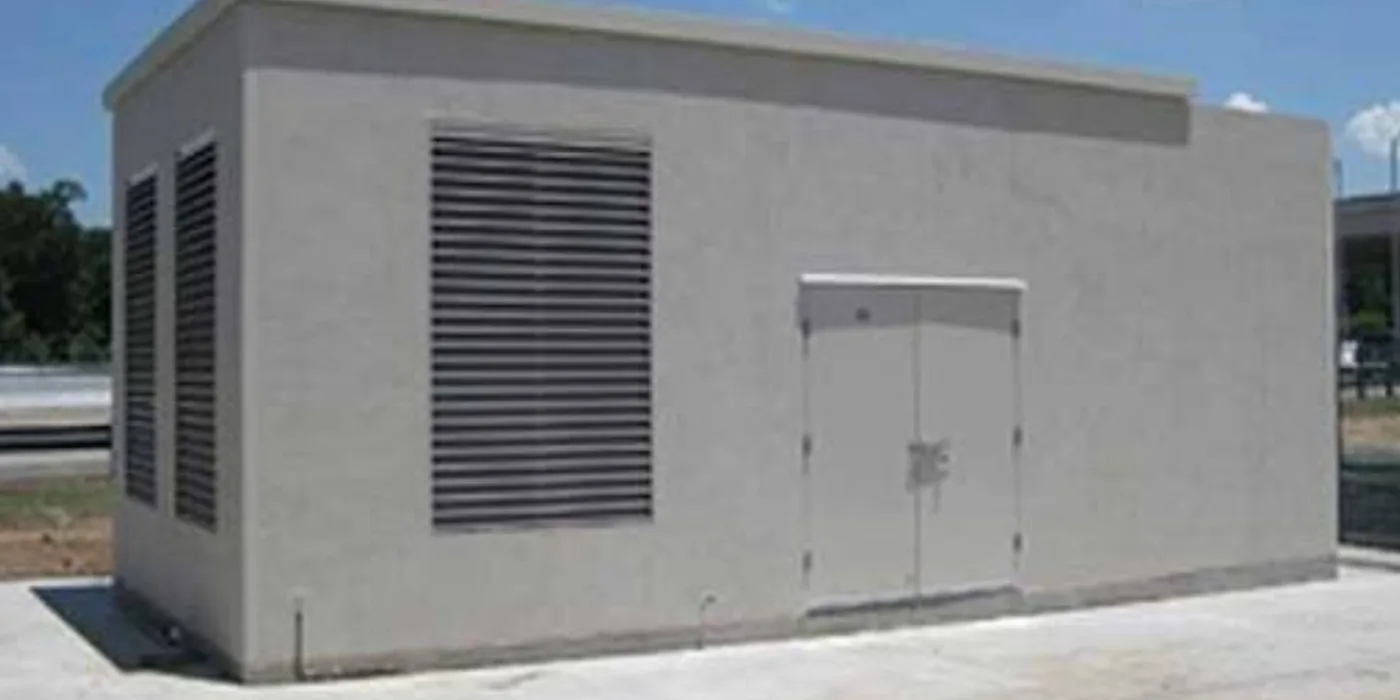Completed masonry generator house with large louvre ventilation panels and secure steel double doors